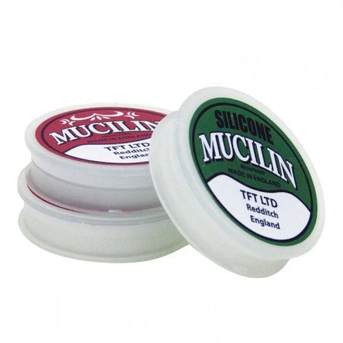 Mucilin line dressing containers with red and green labels, including green-label Silicone Mucilin