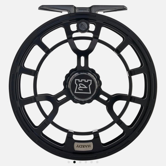 Hardy Averon 5000 large-arbor fly reel in all-black with open spool, black drag knob, Hardy castle logo, and T-bar handle for 7-9wt streamer fishing