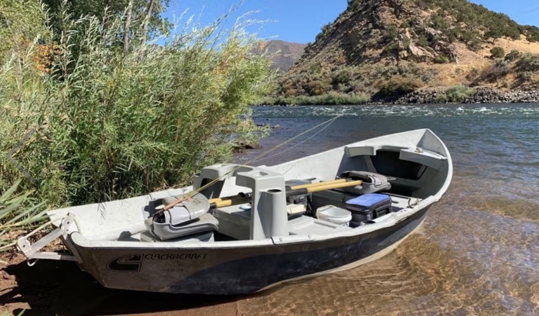 Fishing boat on a river with mountains in the background